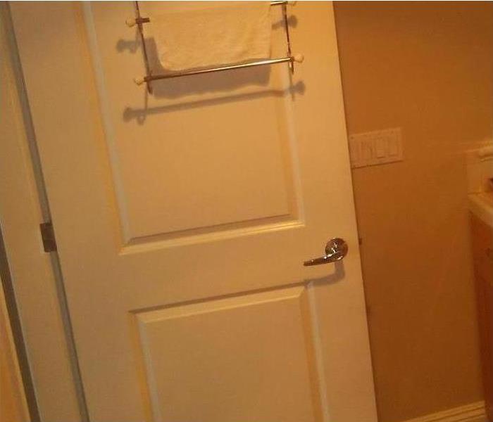bathroom door with damage
