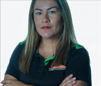 Blonde woman in SERVPRO uniform posing for a picture on a white background
