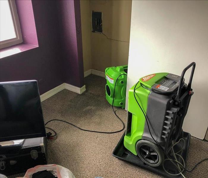 SERVPRO equipment set up to dry water from the carpet of a San Diego home