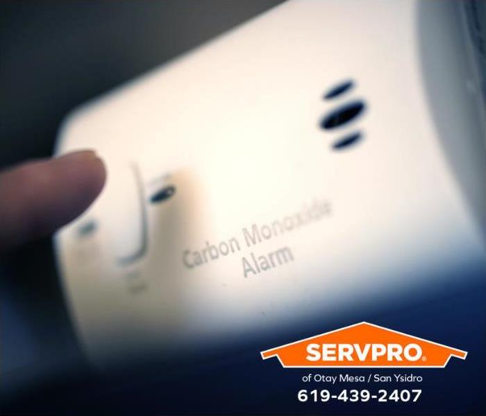 A carbon monoxide sensor is mounted on a wall in a home. 