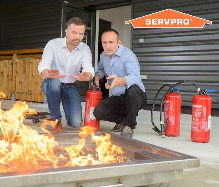 two men testing different fire extinguishers 