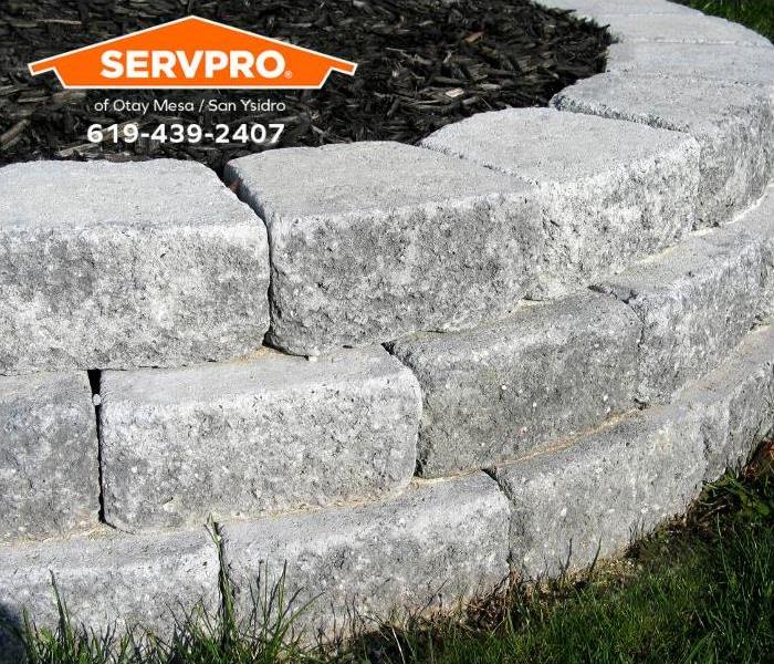 A retaining wall is installed to prevent soil erosion and water intrusion from heavy rains.