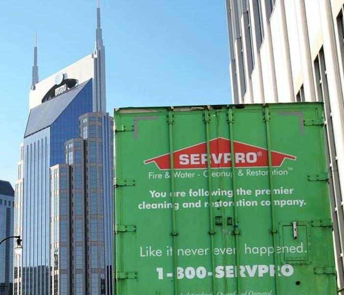 SERVPRO trailer against a city scape background  